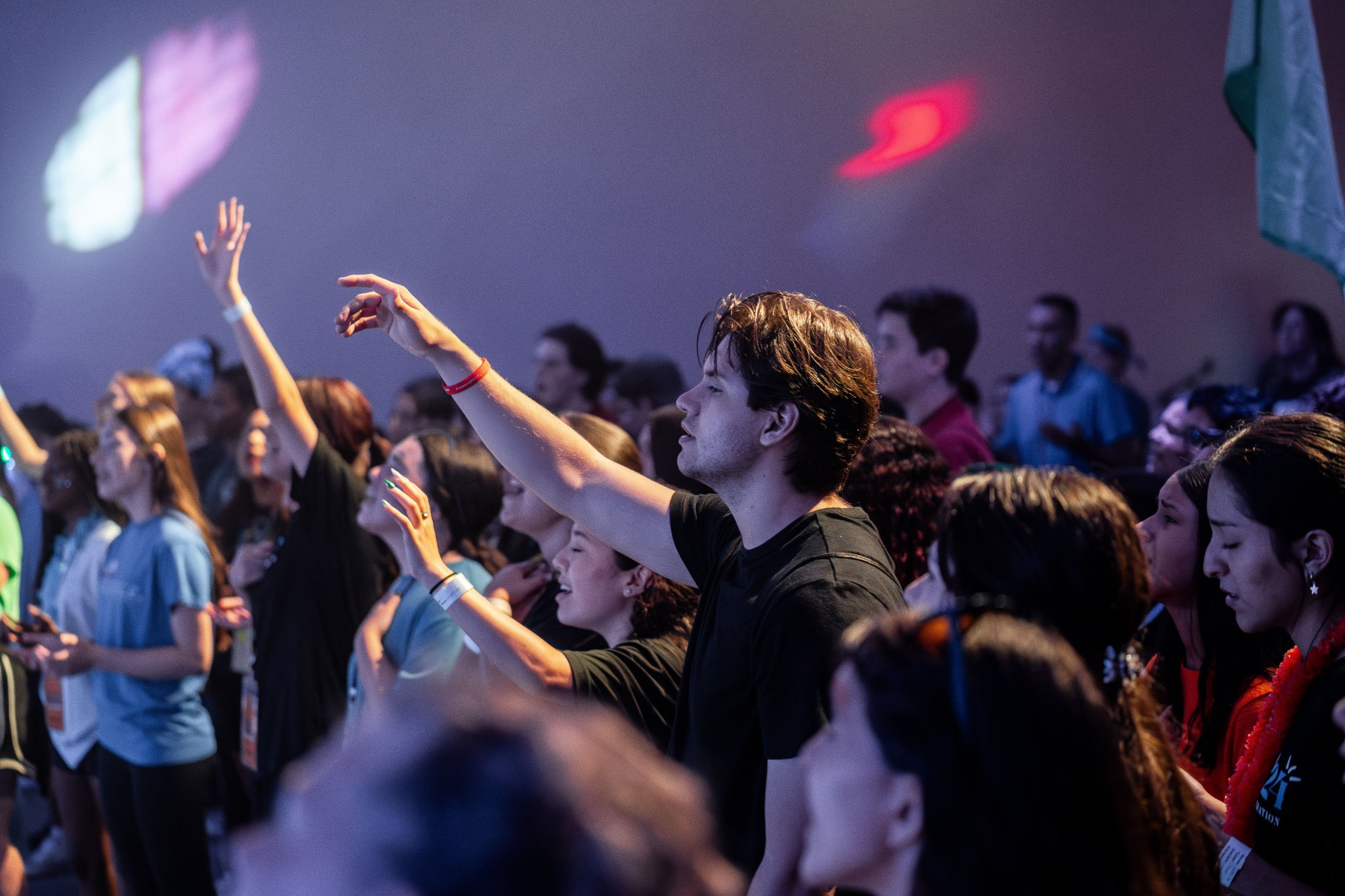 Anthem Youth students worshiping together with hands raised